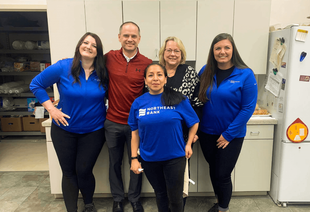 Group of Four NEB employees smiling