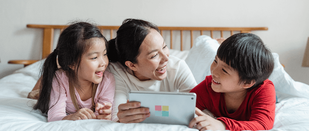 two children and woman on tablet