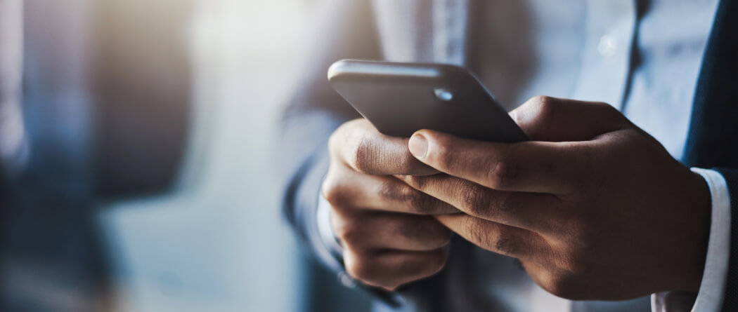 Close-up of a man holding mobile phone